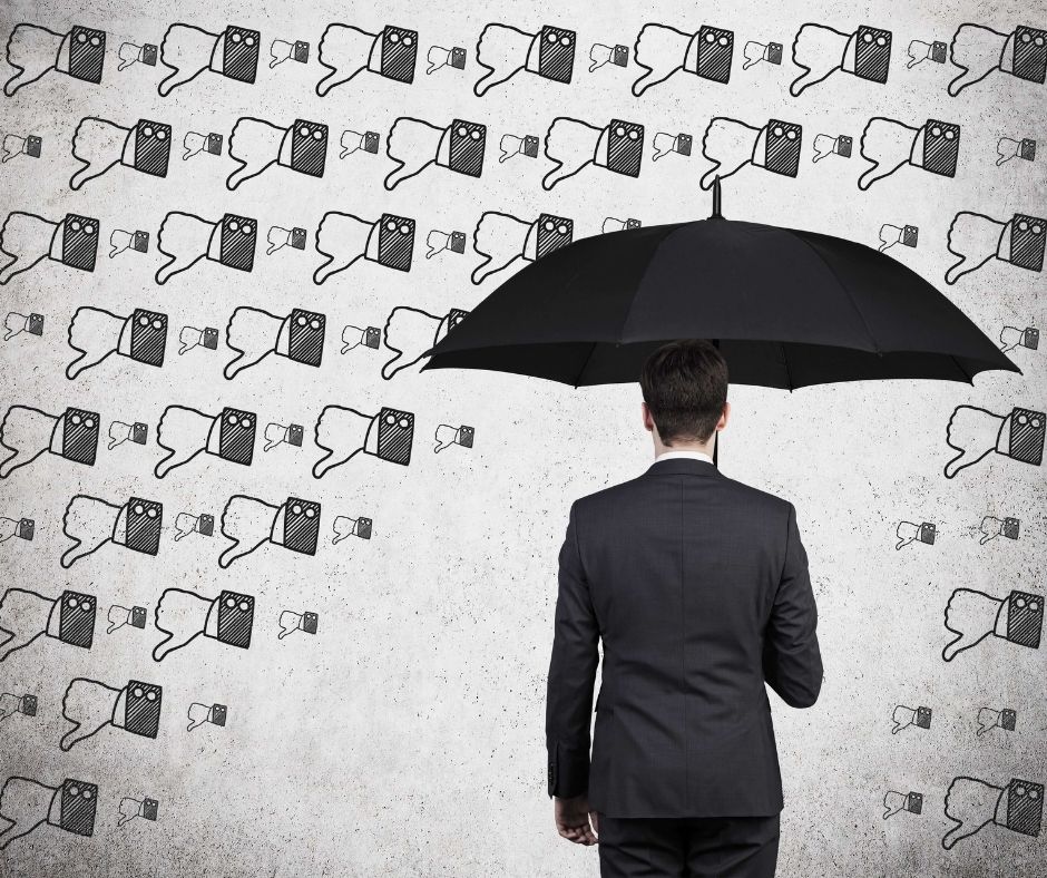 man with umbrella that's showered by thumbs down